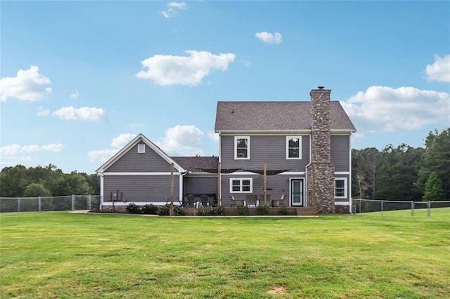 rear view of property with a lawn