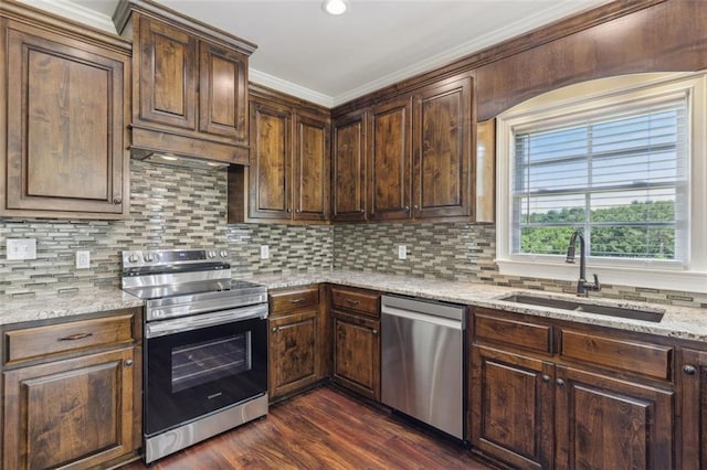 kitchen with dark hardwood / wood-style flooring, sink, light stone countertops, decorative backsplash, and stainless steel appliances