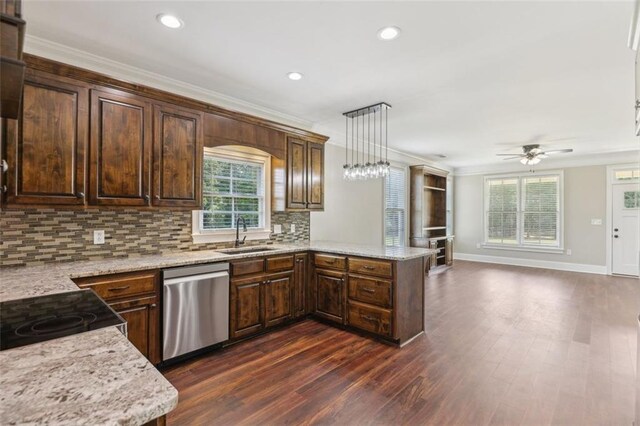 kitchen featuring dishwasher, sink, kitchen peninsula, pendant lighting, and ornamental molding