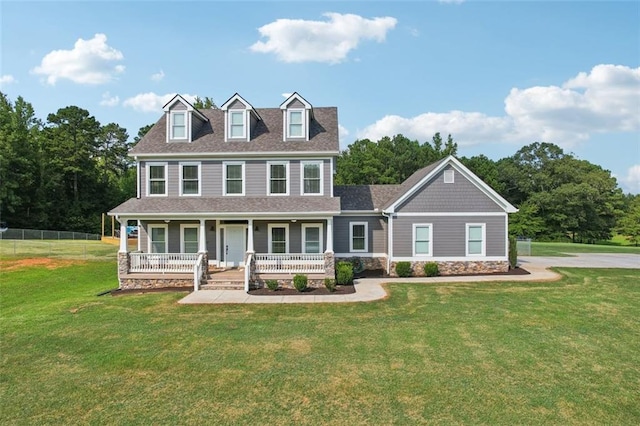 colonial-style house featuring a porch and a front yard