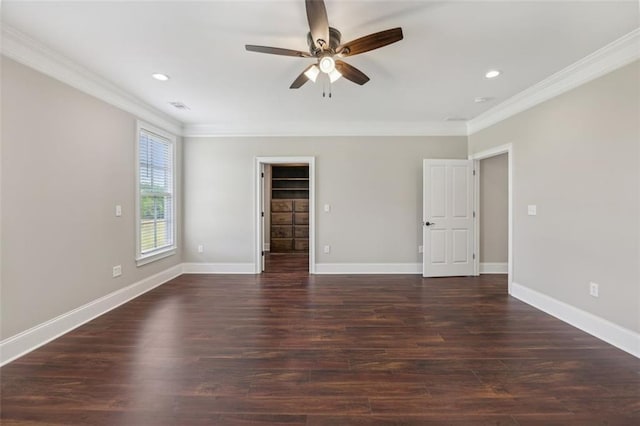 empty room with ceiling fan, ornamental molding, and dark wood-type flooring