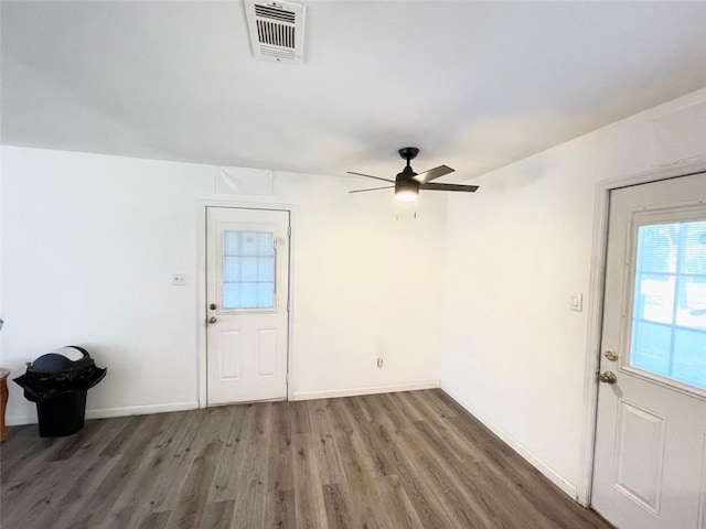 foyer featuring baseboards, visible vents, ceiling fan, and dark wood-type flooring