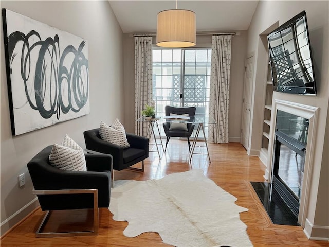 living area with light wood finished floors and baseboards