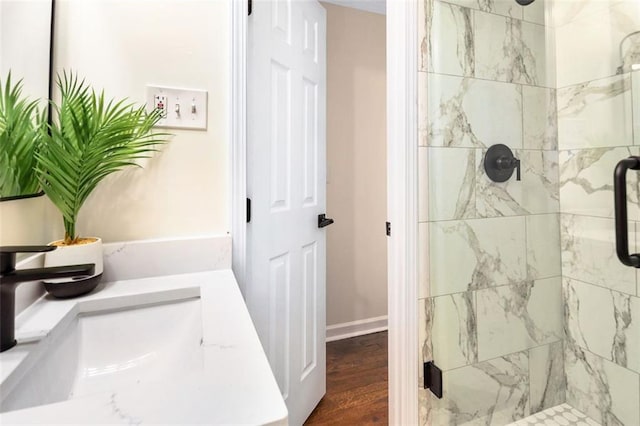 bathroom with wood-type flooring, vanity, and walk in shower