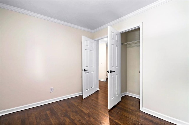 unfurnished bedroom featuring dark hardwood / wood-style flooring, a closet, and ornamental molding