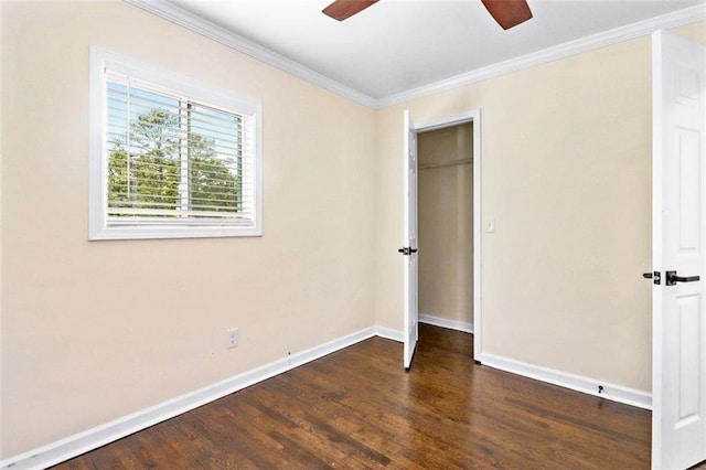 unfurnished bedroom featuring a closet, ceiling fan, dark hardwood / wood-style flooring, and crown molding