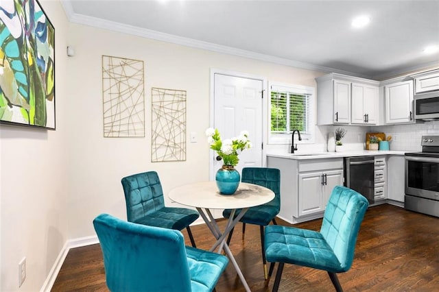 kitchen featuring white cabinets, crown molding, sink, and appliances with stainless steel finishes