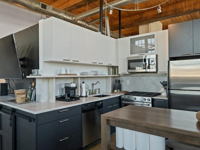 kitchen featuring open shelves, a sink, decorative backsplash, stainless steel appliances, and wood ceiling