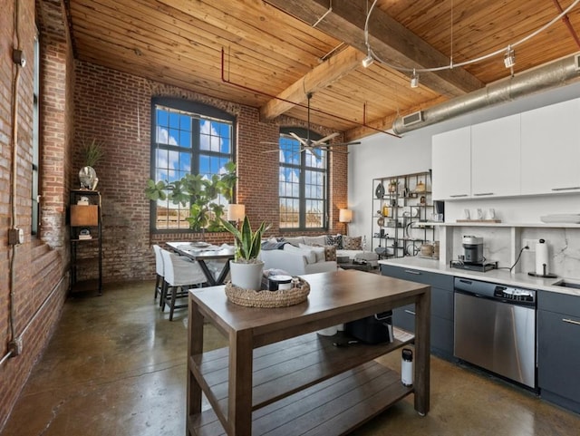 kitchen with concrete floors, dishwasher, brick wall, and wooden ceiling