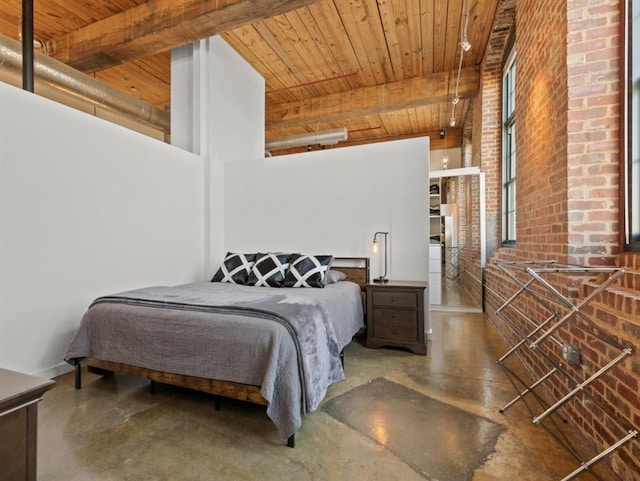 bedroom with beamed ceiling, brick wall, wood ceiling, and concrete floors