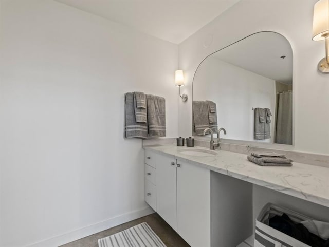 bathroom featuring vanity and baseboards