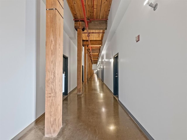 hallway with wood ceiling and a towering ceiling