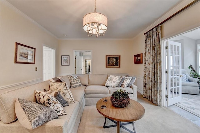 living area featuring light carpet, an inviting chandelier, and ornamental molding