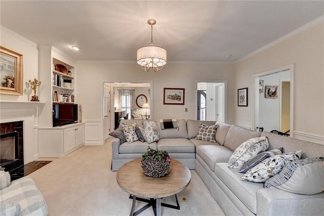 living room with built in features, a premium fireplace, crown molding, carpet floors, and a decorative wall