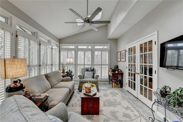 sunroom with ceiling fan, vaulted ceiling, and french doors