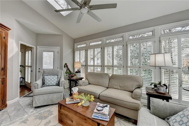 sunroom featuring a healthy amount of sunlight, ceiling fan, and vaulted ceiling