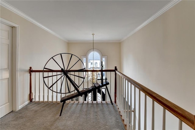 corridor featuring a chandelier, carpet floors, an upstairs landing, and crown molding