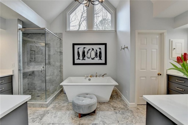 bathroom with a stall shower, baseboards, vaulted ceiling, and a freestanding bath