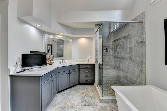 bathroom featuring a freestanding bath, a shower stall, and vanity