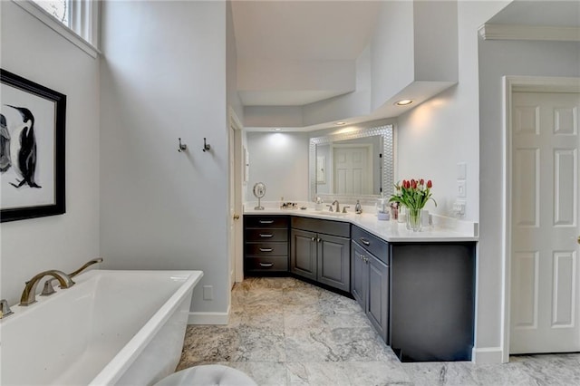 bathroom with a soaking tub, baseboards, and vanity