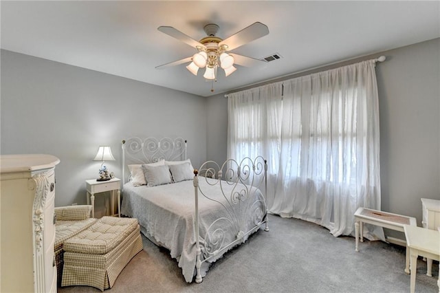 bedroom featuring visible vents, ceiling fan, and carpet flooring