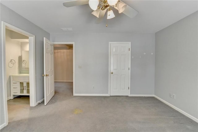 unfurnished bedroom with carpet floors, visible vents, connected bathroom, and baseboards