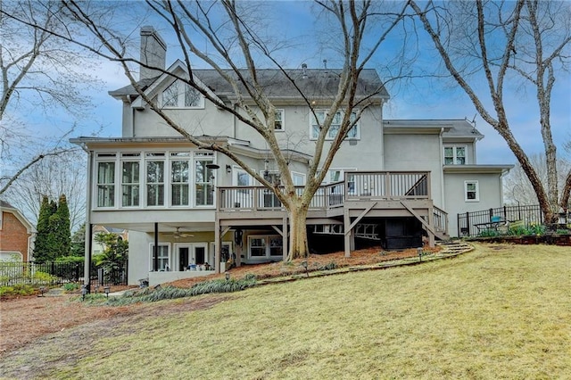 back of house featuring a wooden deck, fence, and stucco siding