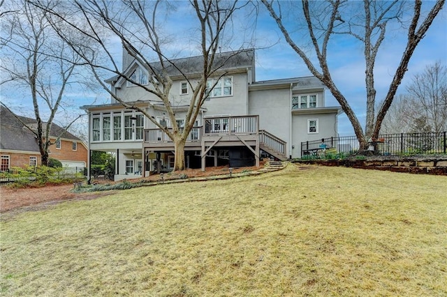 rear view of property featuring a yard, a sunroom, fence, and stairs