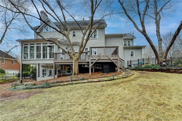 back of property with a wooden deck, stairway, fence, and a sunroom