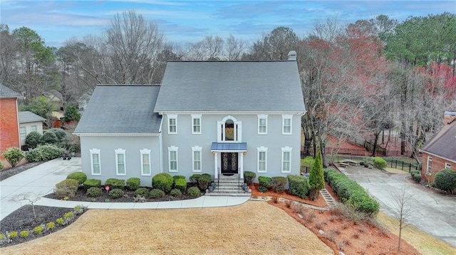 view of front of house featuring a front lawn and stucco siding