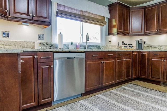 kitchen featuring dishwasher, light stone countertops, and dark brown cabinets