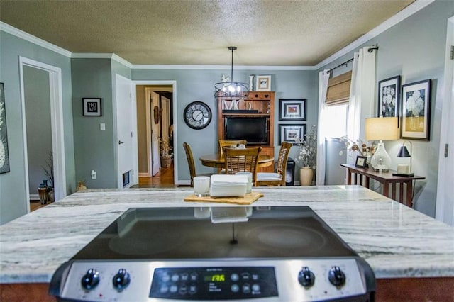kitchen featuring electric range, a chandelier, a textured ceiling, crown molding, and light stone counters
