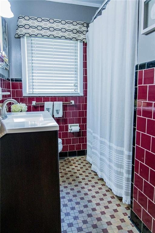 full bath featuring tile walls, toilet, tile patterned floors, vanity, and a shower with shower curtain
