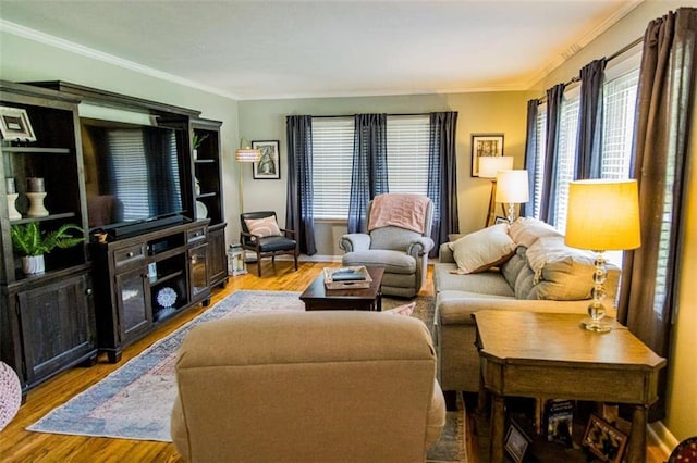 living room featuring ornamental molding, wood finished floors, and baseboards