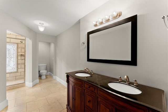 bathroom featuring walk in shower, tile patterned flooring, vanity, and toilet