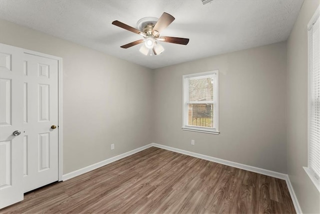 unfurnished bedroom featuring a closet, ceiling fan, and hardwood / wood-style floors