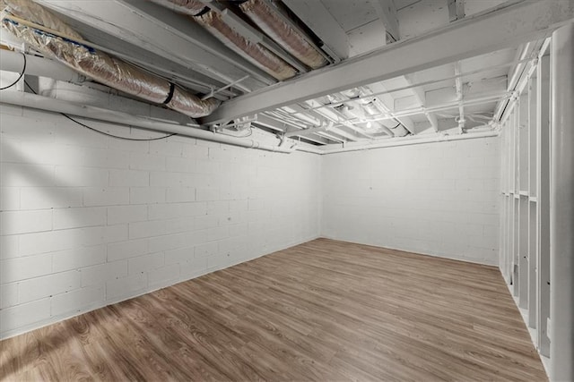 basement with light hardwood / wood-style flooring