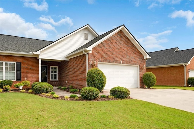 view of front of property with a garage and a front lawn