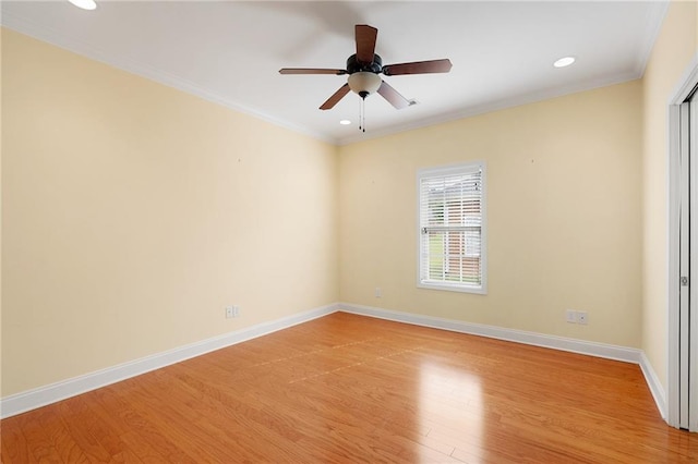 empty room featuring ceiling fan, light wood-type flooring, and ornamental molding