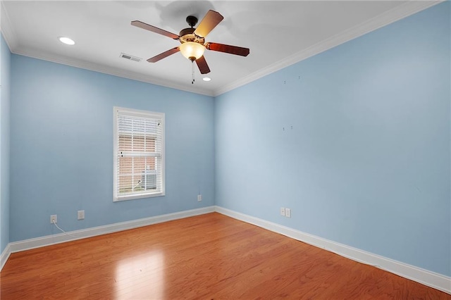 spare room with ceiling fan, light wood-type flooring, and crown molding