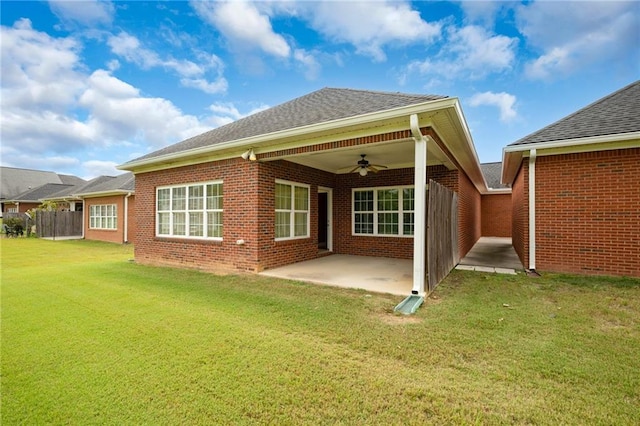 rear view of house featuring a lawn, a patio area, and ceiling fan