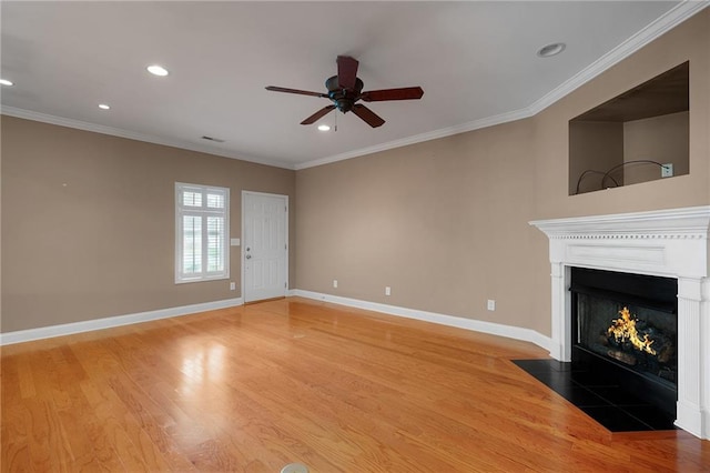 unfurnished living room featuring ceiling fan, wood-type flooring, and ornamental molding