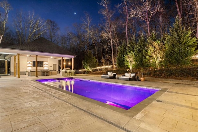 pool at twilight featuring an outdoor living space, a patio, and an outdoor structure