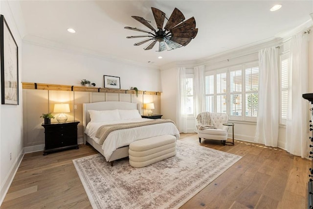 bedroom with crown molding, ceiling fan, and hardwood / wood-style flooring