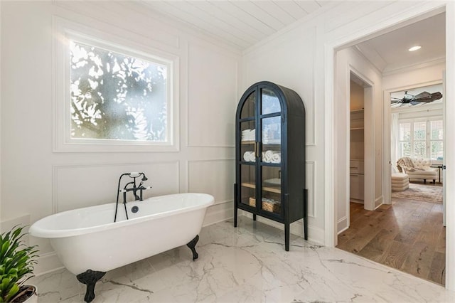 bathroom featuring ornamental molding, a washtub, and ceiling fan