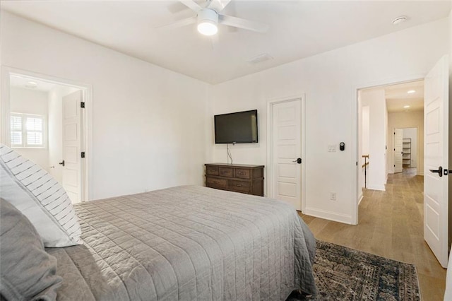 bedroom featuring light hardwood / wood-style floors and ceiling fan