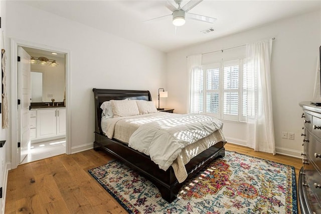 bedroom featuring sink, wood-type flooring, and ceiling fan