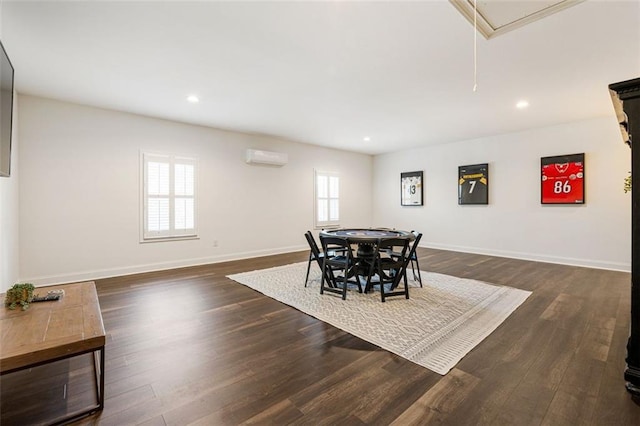 dining area with an AC wall unit and dark hardwood / wood-style floors