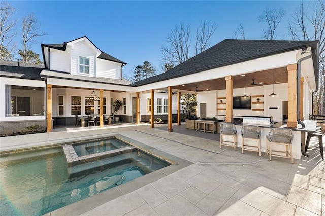 back of property featuring exterior bar, area for grilling, a swimming pool with hot tub, ceiling fan, and a patio area