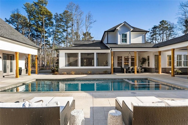 view of swimming pool featuring an outdoor living space, a patio, and french doors